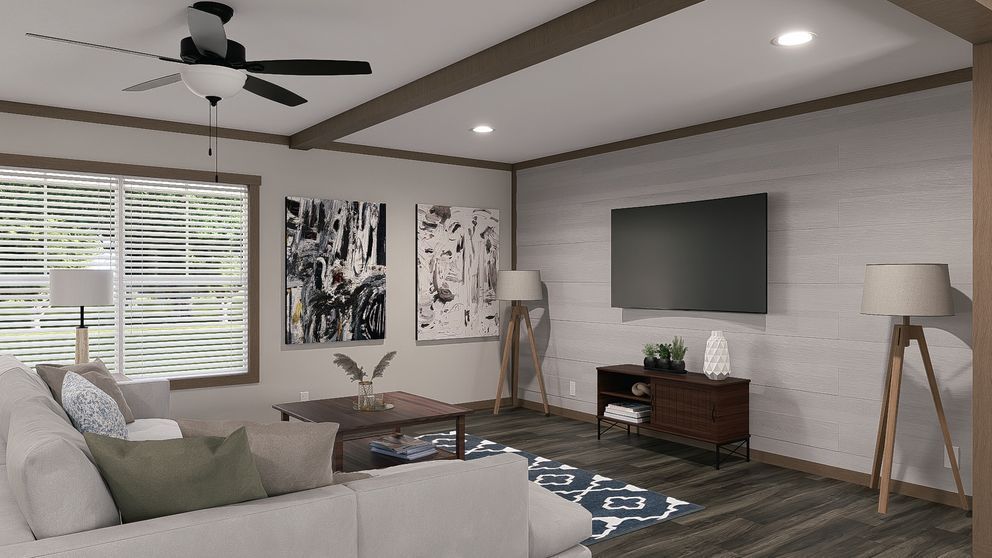 Modern living room with sectional sofa, wall-mounted TV, ceiling fan, and large windows with blinds