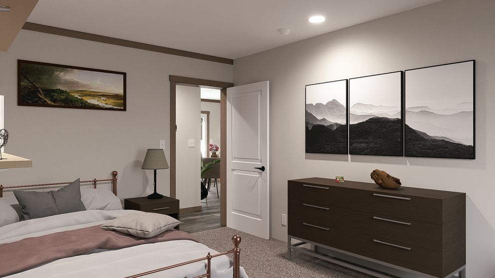 Modern bedroom with a bed, dresser, wall art, and an open door to a bathroom