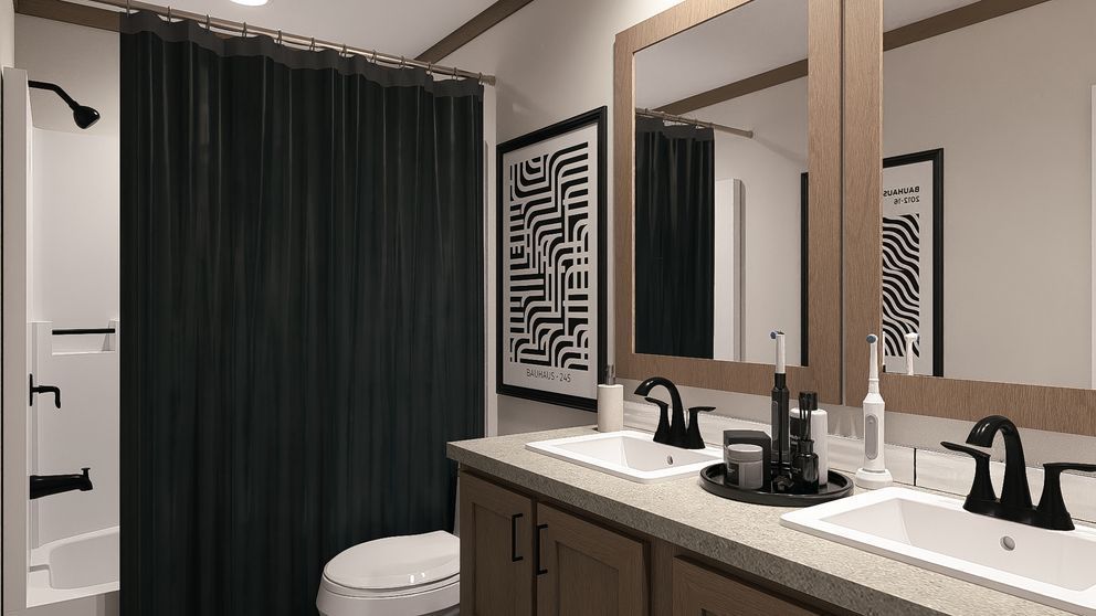 Modern bathroom with double vanity, black fixtures, large mirrors, and dark shower curtain
