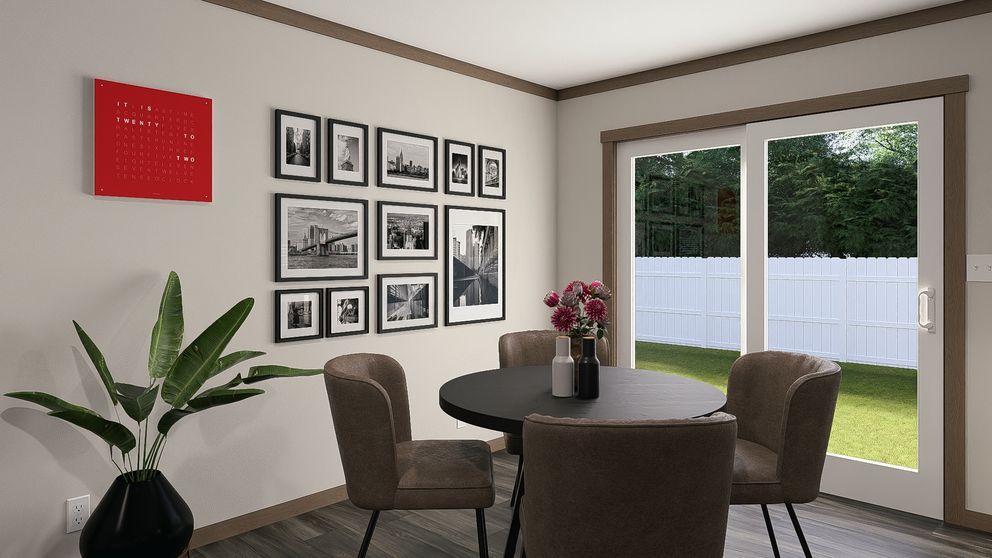Dining room with round table, four chairs, wall art, red decor, and large windows overlooking a backyard