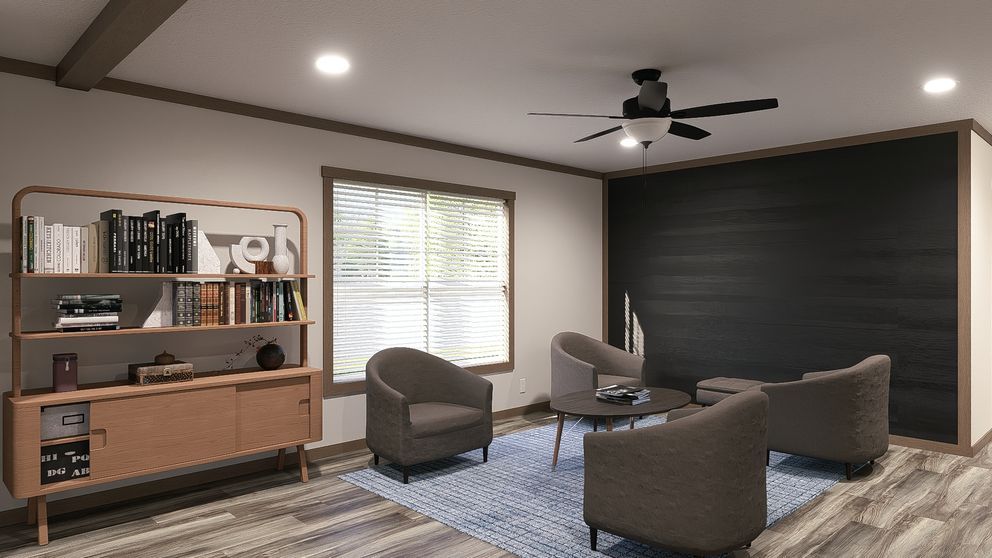 Modern living room with brown chairs, dark accent wall, bookshelf, window, and ceiling fan