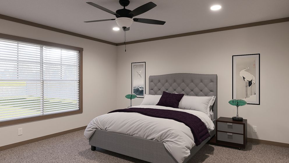 Modern bedroom with a gray upholstered bed, white bedding, bedside tables, and a ceiling fan.