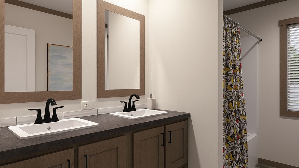 Modern bathroom vanity with double sinks, dark cabinets, and mirrors beside a shower curtain and window.