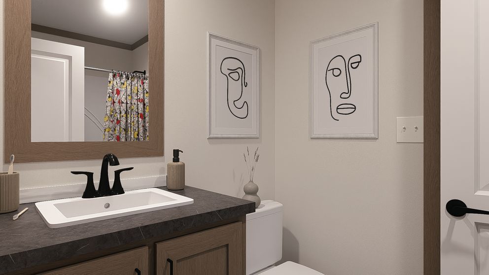 Modern bathroom with vanity, mirror, toilet, and minimalist line art on the wall.