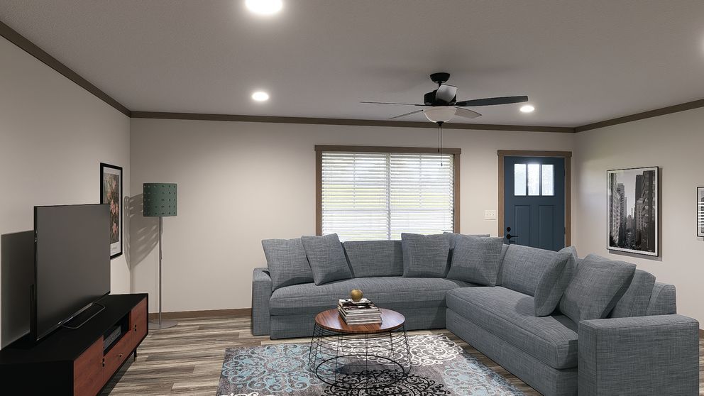 Living room with gray sectional sofa, TV, coffee table, ceiling fan, and window blinds