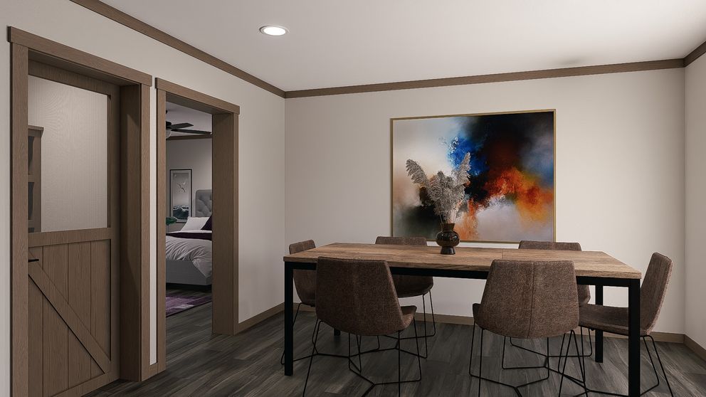Modern dining room with a wooden table, upholstered chairs, and abstract wall art under recessed lighting.