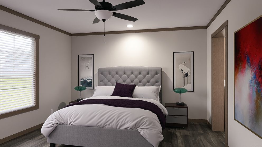 Modern bedroom with a tufted bed, ceiling fan, windows, and abstract wall art
