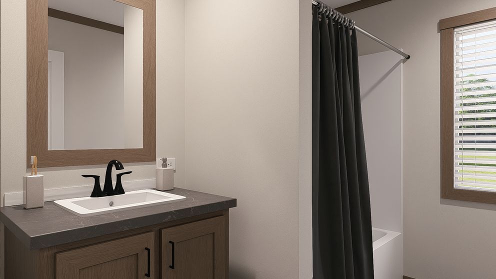 Modern bathroom with vanity sink, mirror, and dark shower curtain near a window with blinds