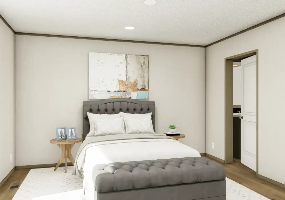 Bright modern bedroom with a white bed, gray tufted bench, and small side table
