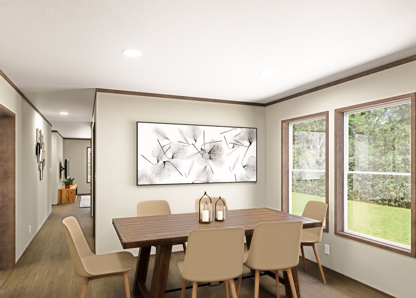 Modern dining room with wooden table, beige chairs, wall art, and large windows overlooking greenery