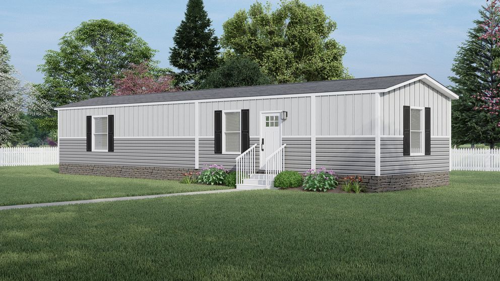 Single-story gray manufactured home with small front porch on a grassy lot under a blue sky
