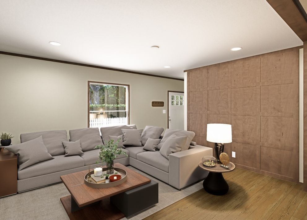 Modern living room with gray sectional sofa, coffee table, lamp, and wood accent wall