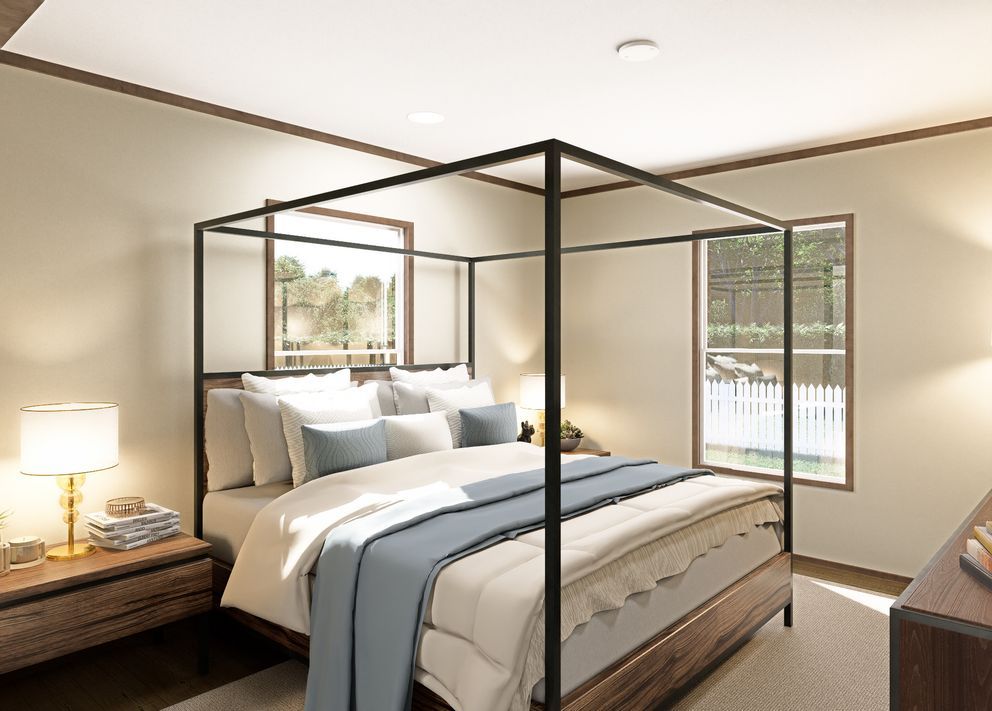 Modern bedroom with a black canopy bed, white bedding, wooden nightstands, and large windows.