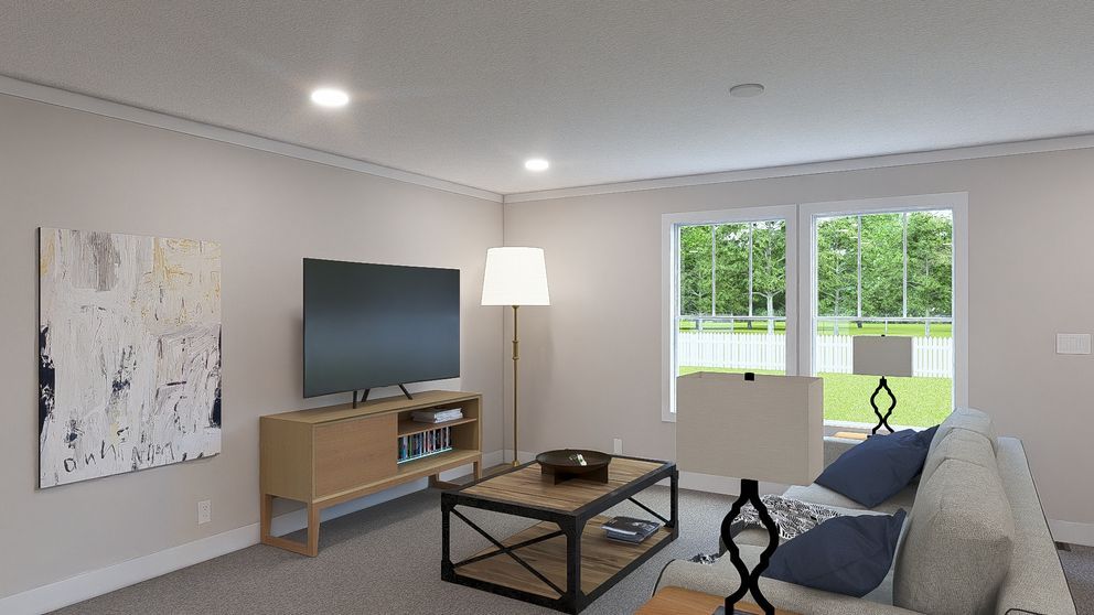 Modern living room with TV, couch, coffee table, floor lamp, and large windows overlooking greenery