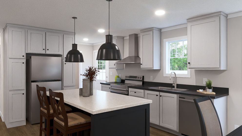 Modern kitchen with white cabinets, gray island, pendant lights, and barstools by a stainless steel fridge.