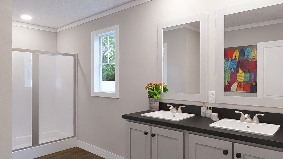Modern bathroom with double vanity, large mirrors, white shower, and colorful wall art.