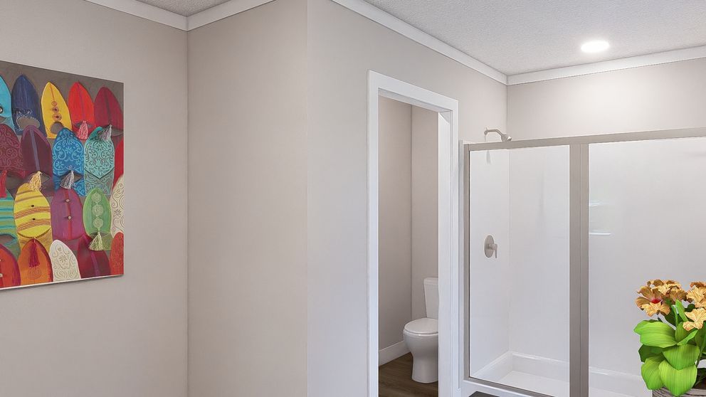 Bright hallway with an open bathroom door, shower stall, and colorful wall art.