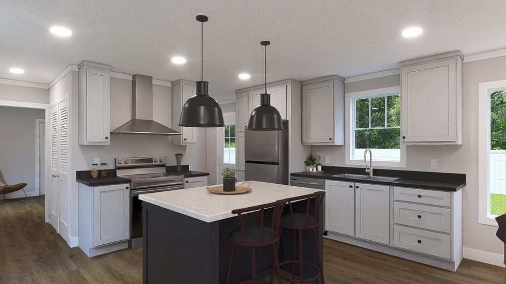 Bright modern kitchen with white cabinets, black island, pendant lights, and wood floors