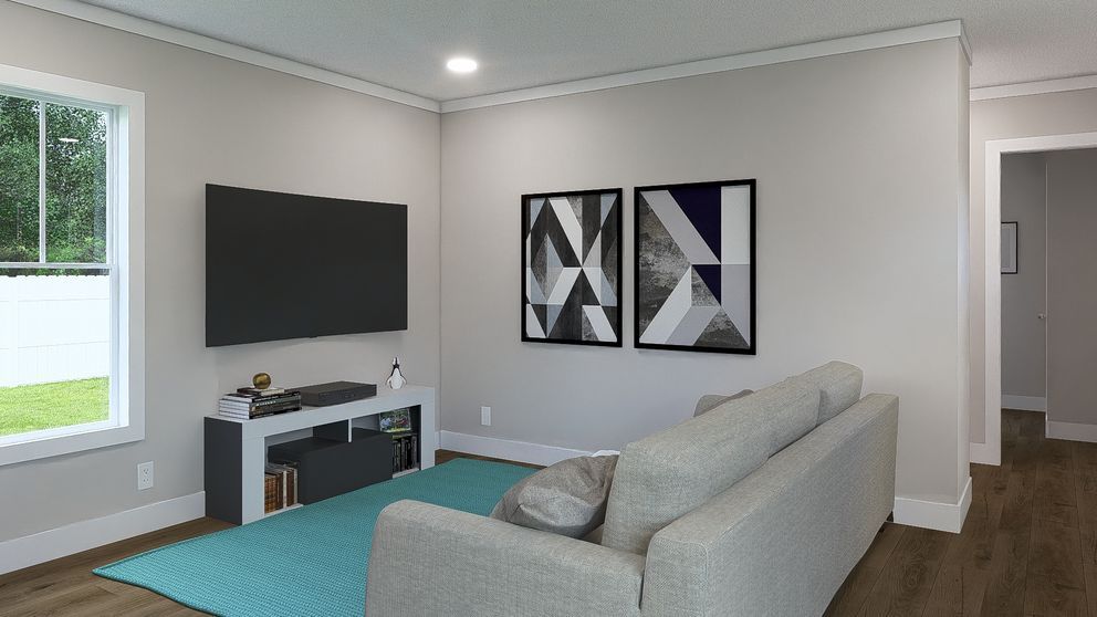 Modern living room with gray sofa, wall-mounted TV, abstract art, and teal rug