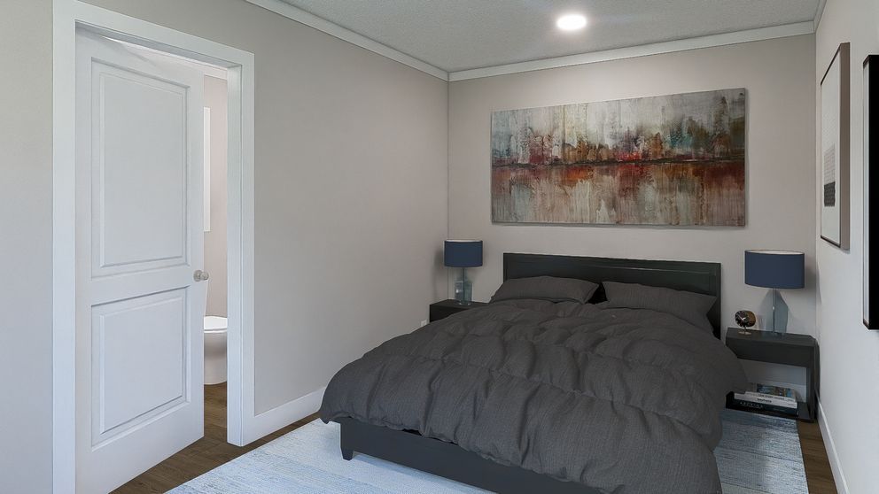 Bright bedroom with gray bed, abstract wall art, bedside lamps, and an open doorway