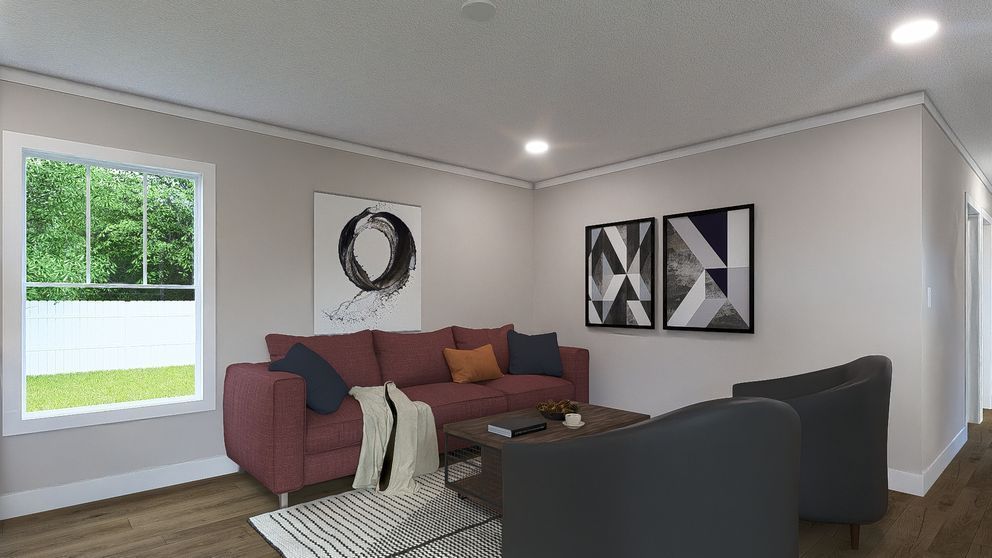 Modern living room with a maroon sofa, black chairs, abstract wall art, and a large window.