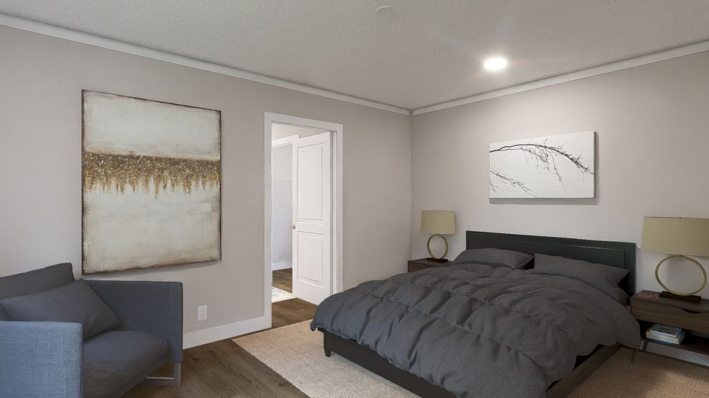 Modern gray bedroom with a large bed, abstract wall art, and a blue sofa near a doorway