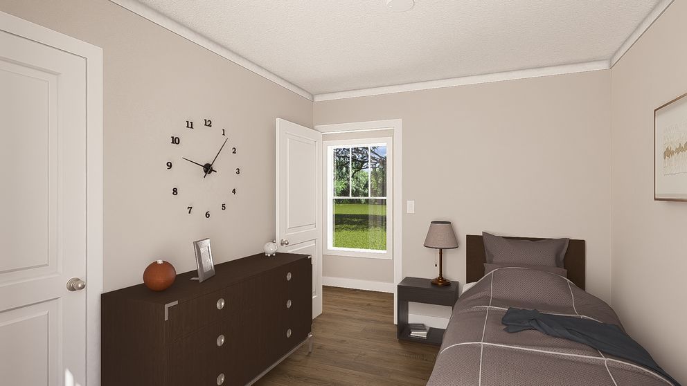 Bright bedroom with a bed, dresser, wall clock, and open door to a green yard.