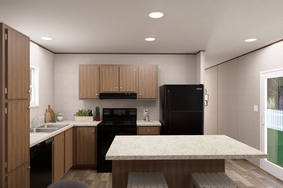 Modern kitchen with light wood cabinets, black appliances, and a large island under recessed lights