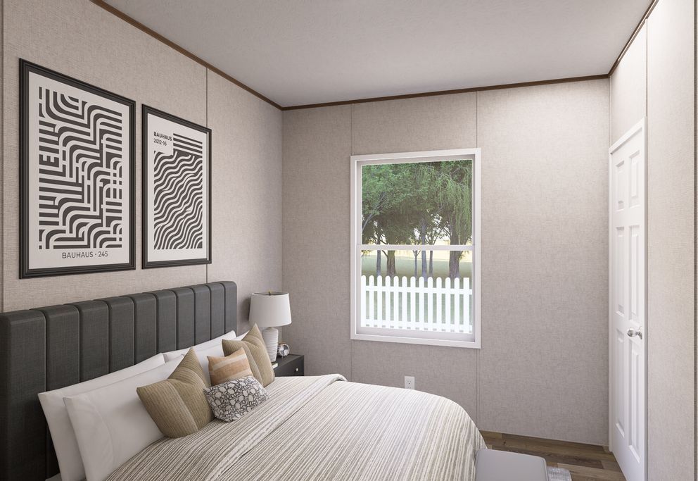 Minimal bedroom with gray bed, framed wall art, window, and white walls