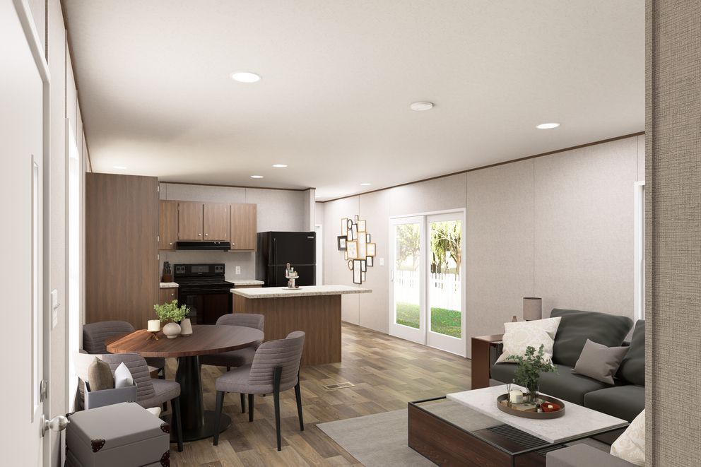 Modern open-plan living room and kitchen with gray sofa, dining table, and sliding glass doors