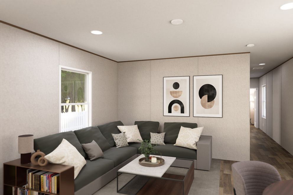 Modern living room with gray sectional sofa, coffee table, wall art, and soft neutral decor.