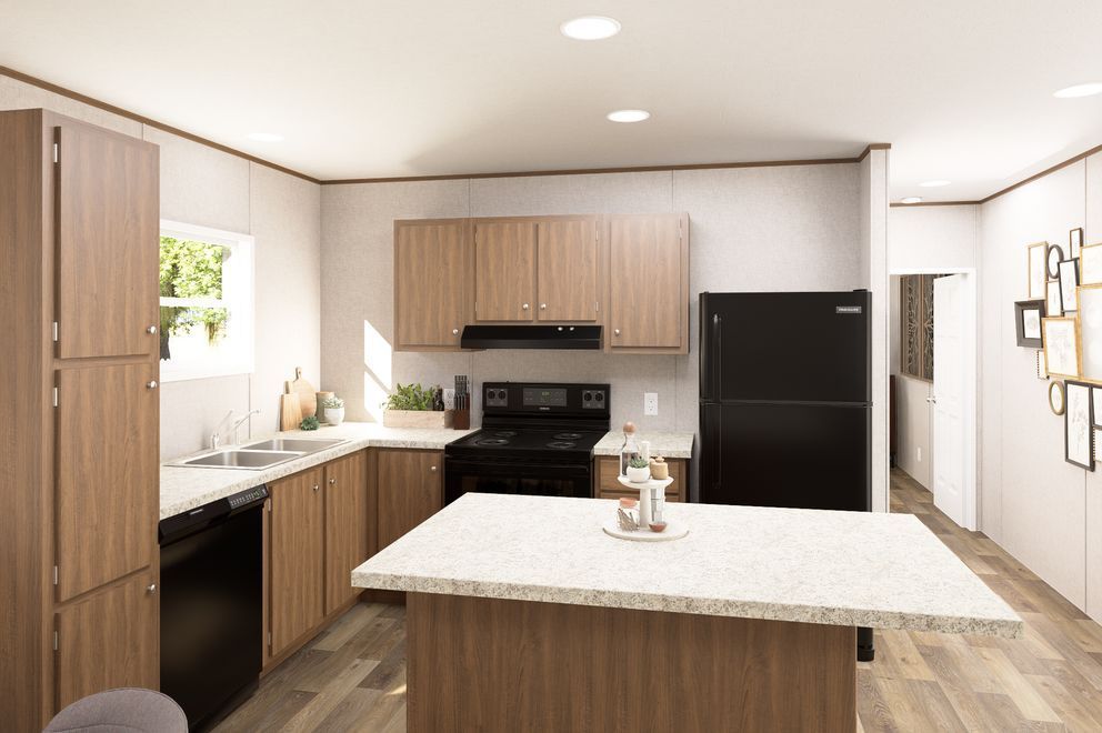 Bright modern kitchen with light wood cabinets, black appliances, and a large island countertop