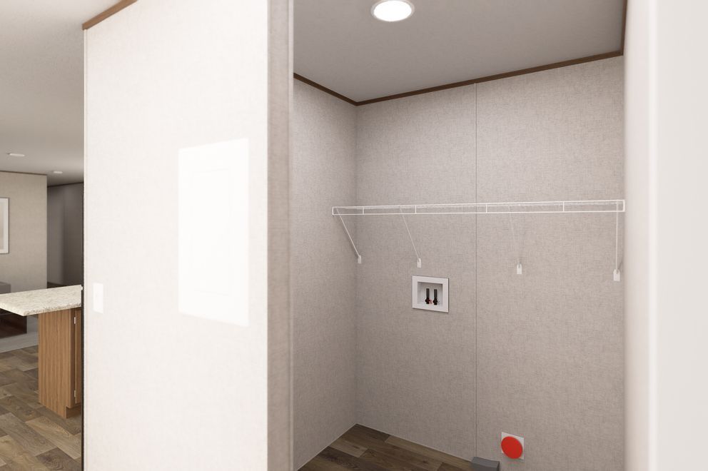 Empty closet alcove with white wire shelf, beige walls, and recessed ceiling light