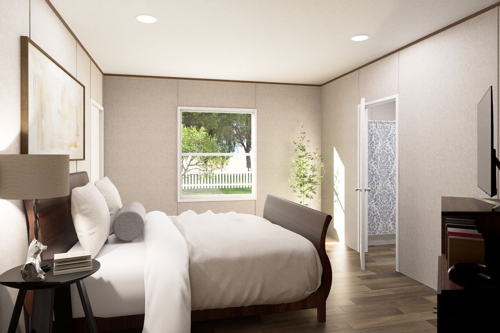Modern bedroom with a bed, nightstand lamp, window, and dark wood flooring