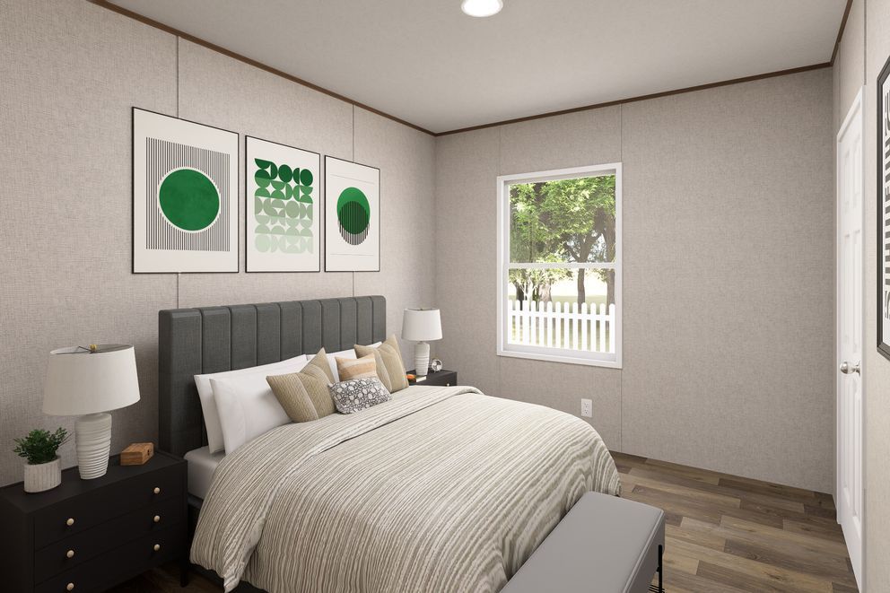 Modern bedroom with gray bed, framed wall art, nightstand, and a window with daylight.