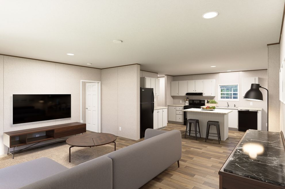 Modern open-plan living room and kitchen with gray sofa, wall TV, wood floors, and black countertops