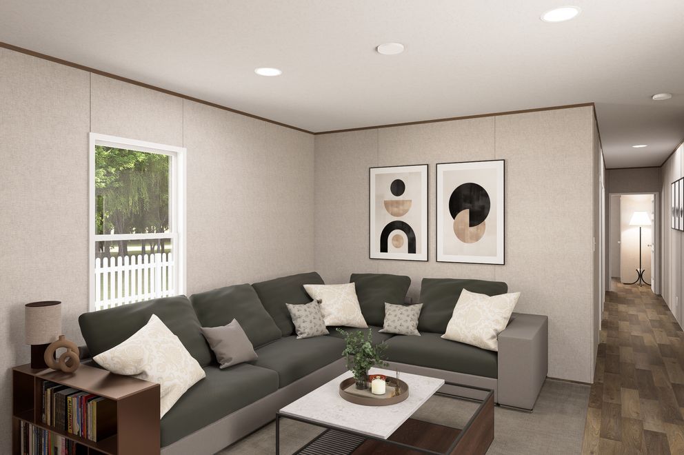 Modern living room with gray sectional sofa, coffee table, wall art, and hallway view