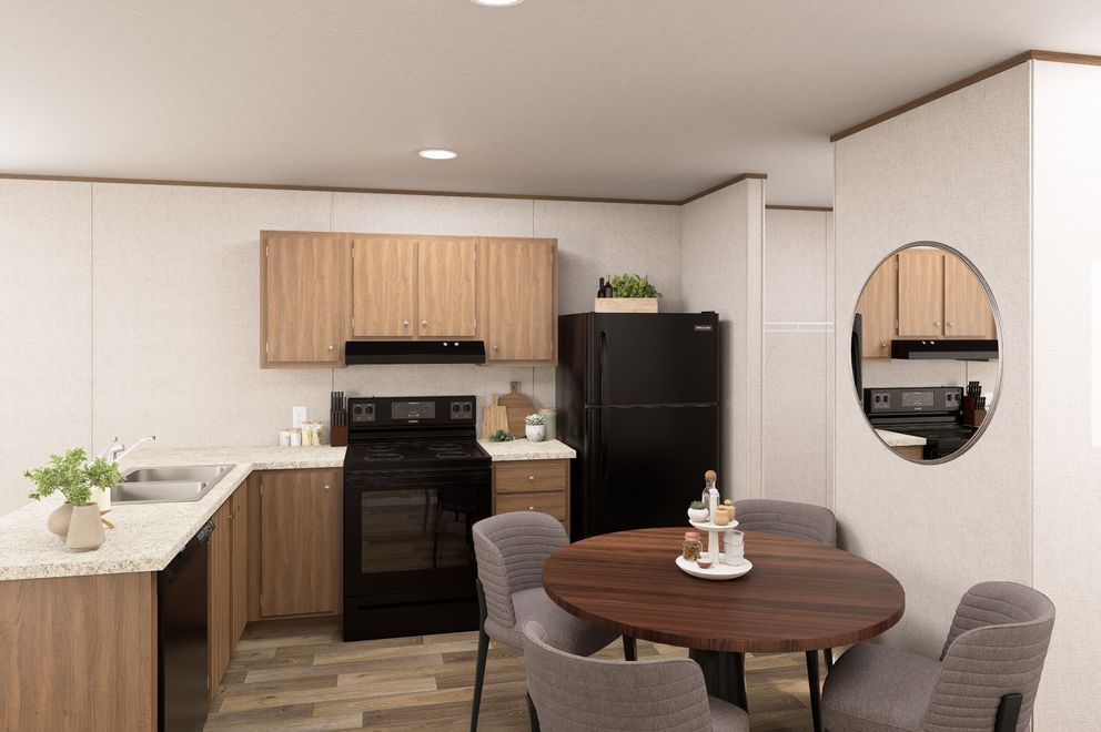 Modern kitchen and dining area with wood cabinets, black stove, round table, and wall mirror