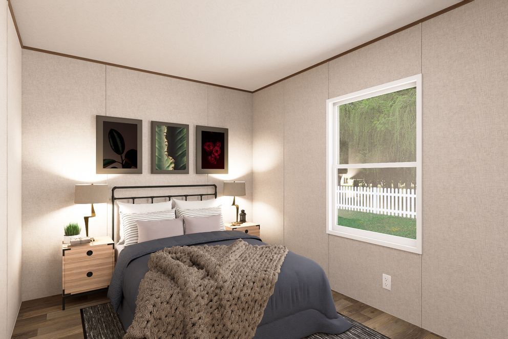 Cozy bedroom with gray bedding, bedside lamps, wall art, and a window overlooking a porch