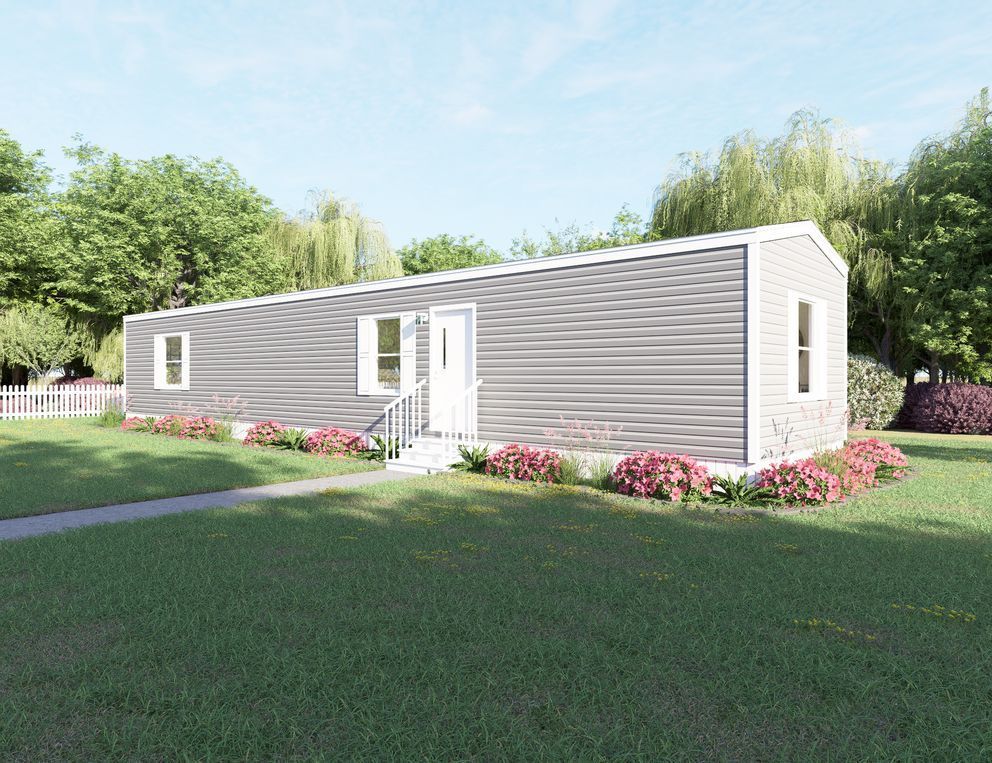 Single-story gray house with white trim, set on a grassy lot with flowers and trees.