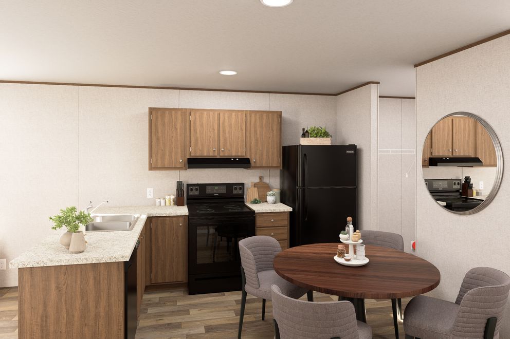 Modern kitchen and dining area with wood accents, black appliances, and a round table with chairs.