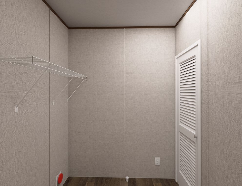 Empty closet with beige walls, white wire shelves, louvered door, and dark wood floor.