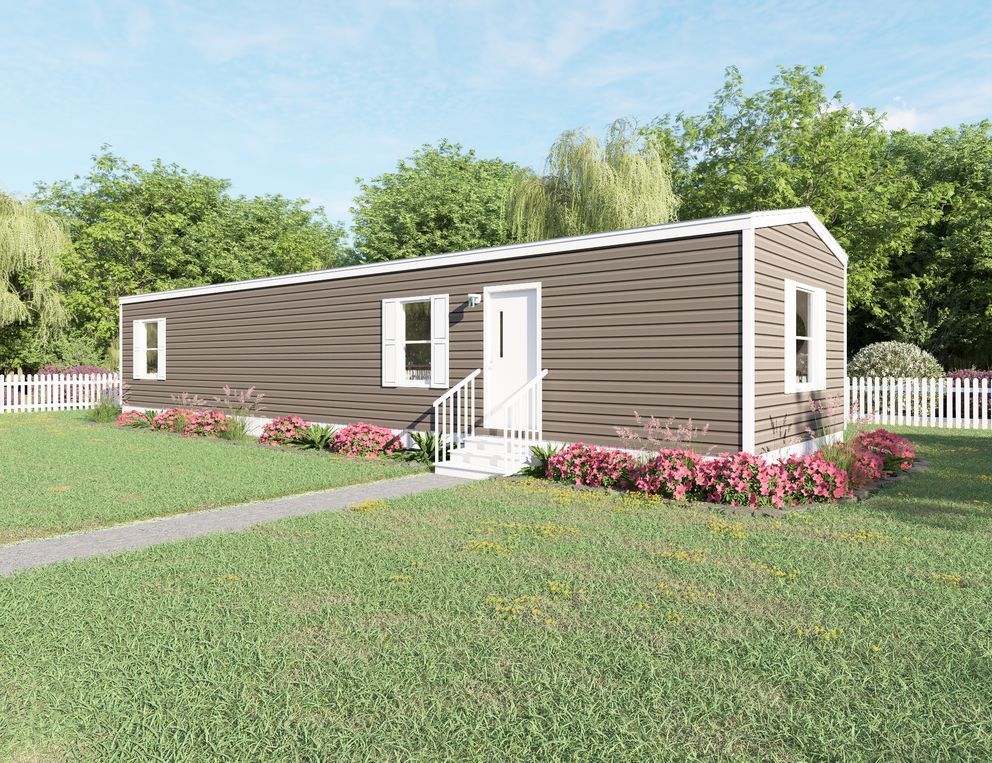 Single-story brown modular home with white trim, front steps, lawn, flower beds, and trees behind it