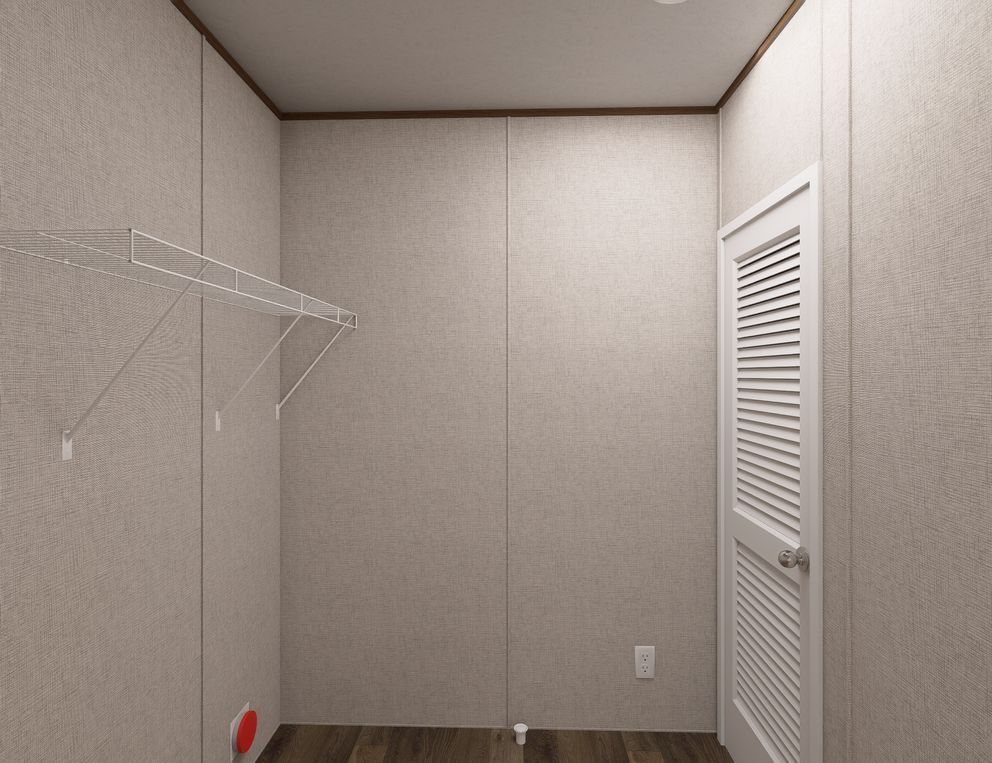Empty beige closet with wire shelving and a louvered door on the right.