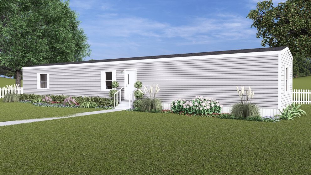 Modern white single-story house with a lawn and trees under a clear blue sky
