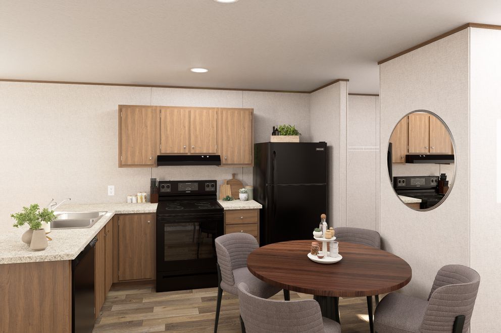 Modern kitchen and dining area with wood cabinets, black stove, round table, and circular wall mirror