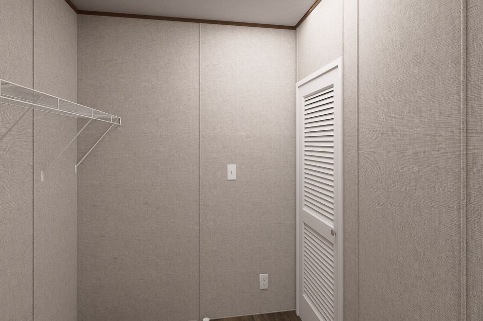 Empty beige closet with white louvered door and wire shelving on the left