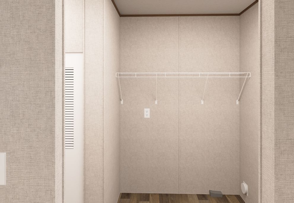 Empty beige closet with a white hanging rod and vented panel on the left.