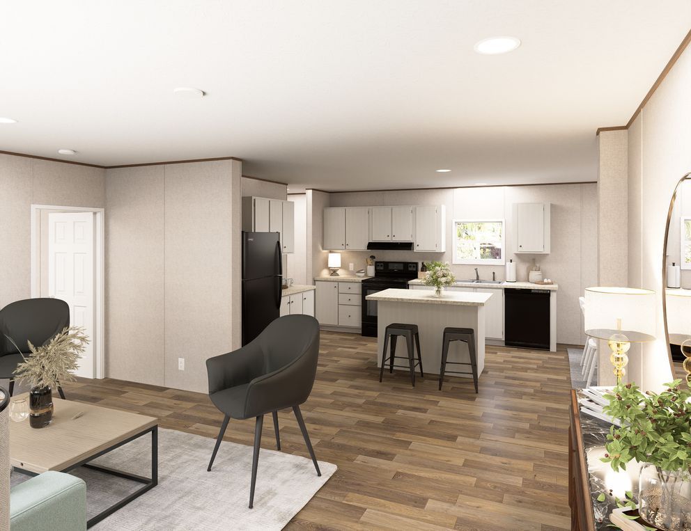 Modern open-plan living room and kitchen with wood floors, gray chairs, and a kitchen island.