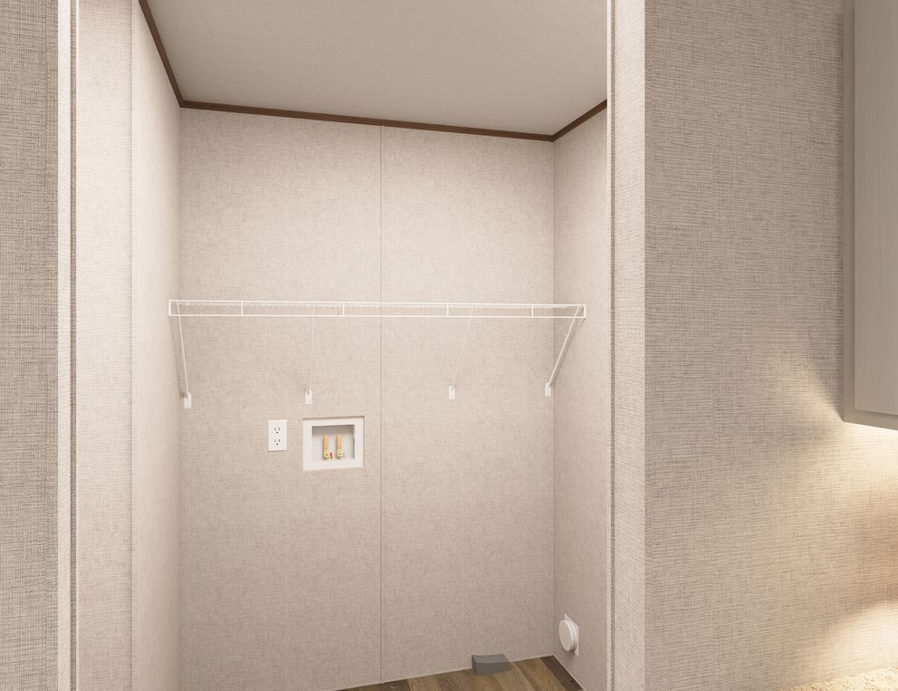 Empty beige closet with a white hanging shelf and a small wall panel on the back wall.